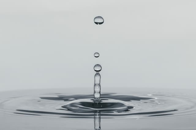 Zen water splashing upward from impact
