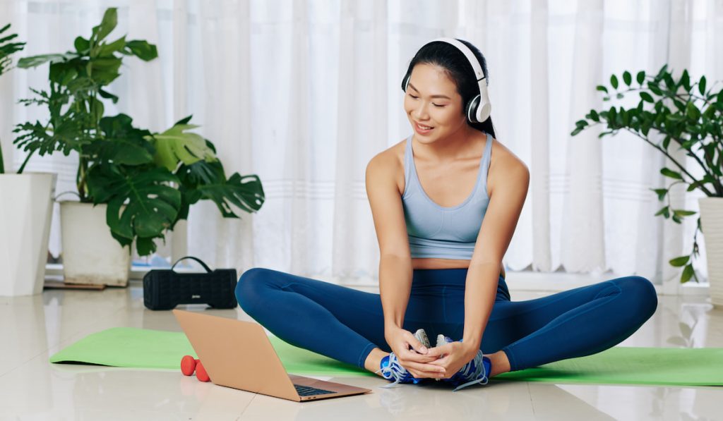 Woman doing butterfly stretch at home